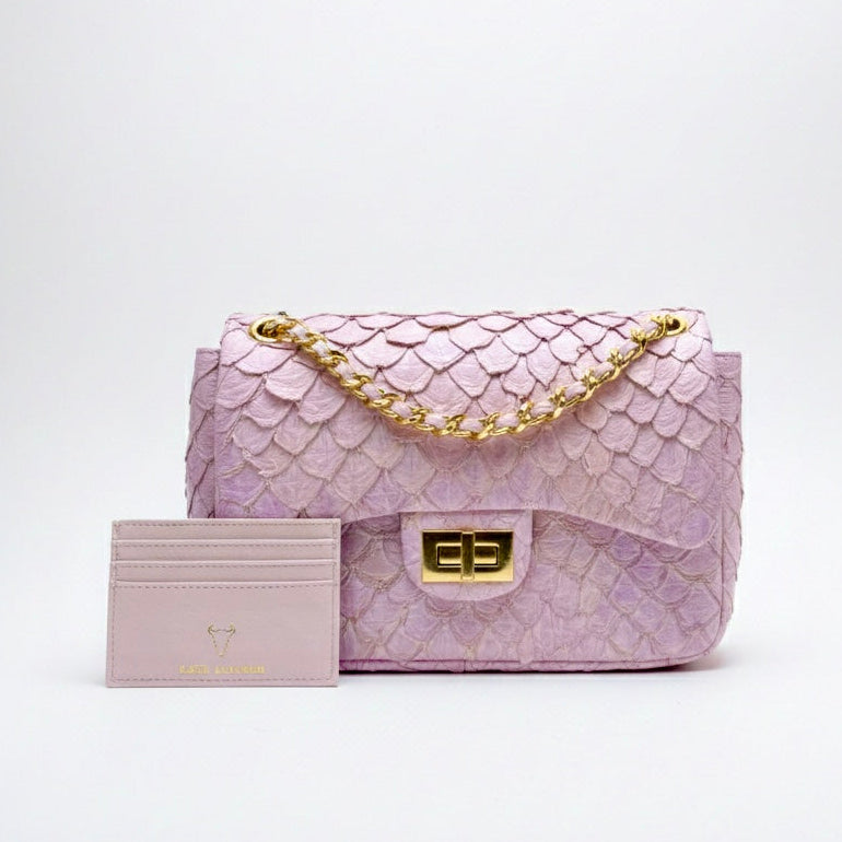 Pink textured handbag with gold accents on a white background