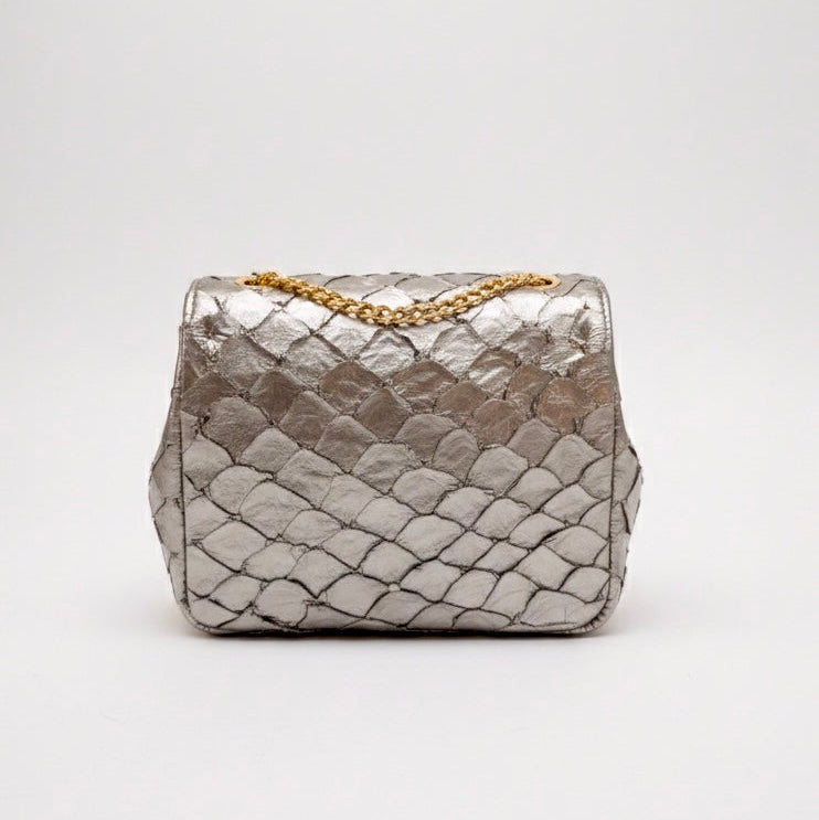 Silver textured handbag with a gold chain on a white background
