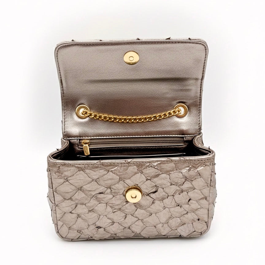 Open beige handbag with gold chain and clasp on a white background